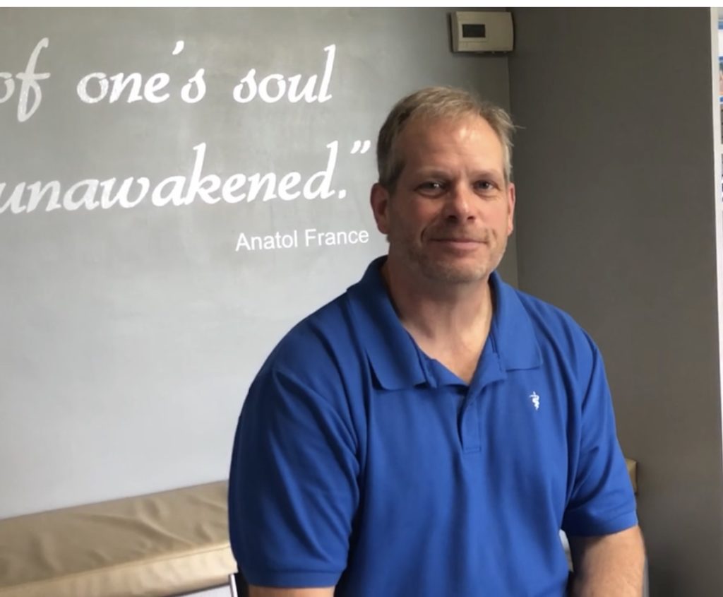 A person in a blue shirt
Description automatically generated